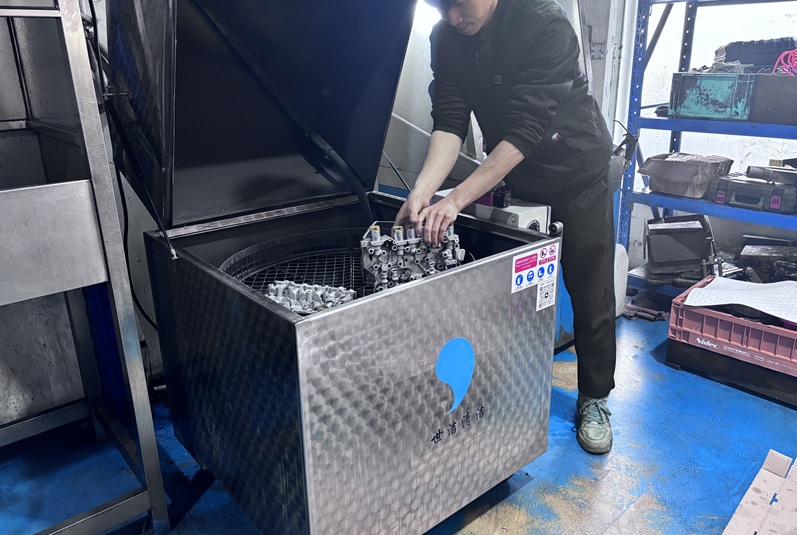Valve body components being cleaned in an ultrasonic tank during remanufacturing